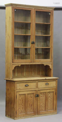A Victorian pine kitchen dresser, fitted with two glazed doo...