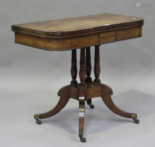 A Regency mahogany fold-over card table with ebony stringing...