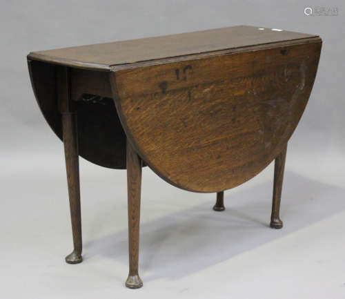 A 19th century oak oval drop-flap breakfast table, on turned...