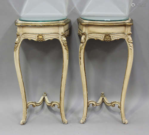 A pair of 20th century Louis XV style cream and gilt painted...