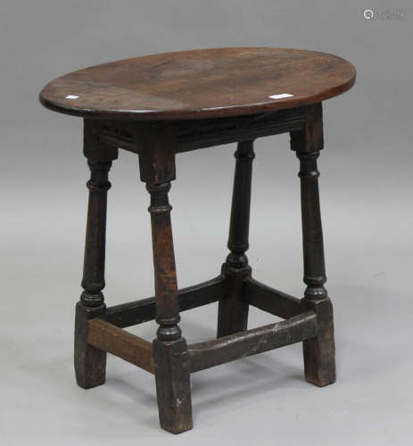 A 17th century oak joint stool base with later oval top, on ...