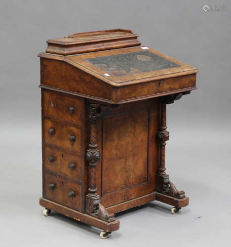 A late Victorian walnut Davenport, the hinged writing surfac...