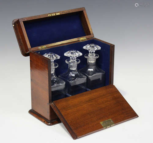 A late 19th century mahogany three-bottle decanter case, the...