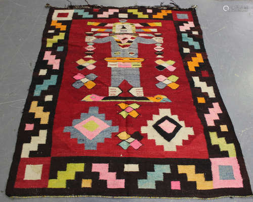 A Peruvian flatweave rug, mid-20th century, the red field wi...