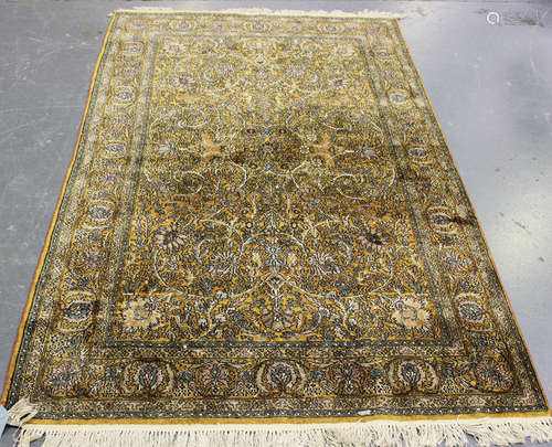 A Kashmir part silk rug, mid/late 20th century, the chestnut...