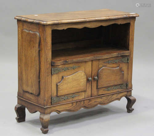 A 20th century French oak low side cupboard, fitted with a p...