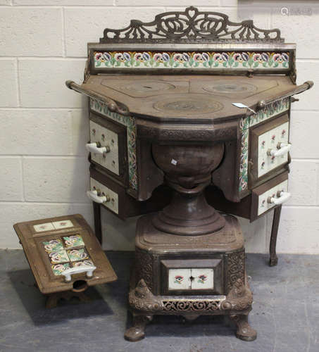 A large late 19th/early 20th century French cast iron stove,...