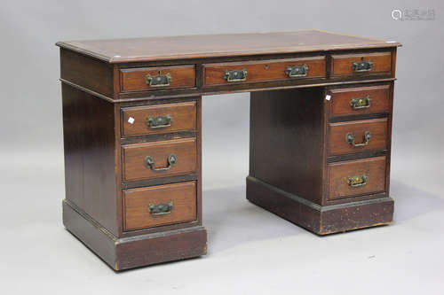 A late Victorian mahogany twin pedestal desk, fitted with an...