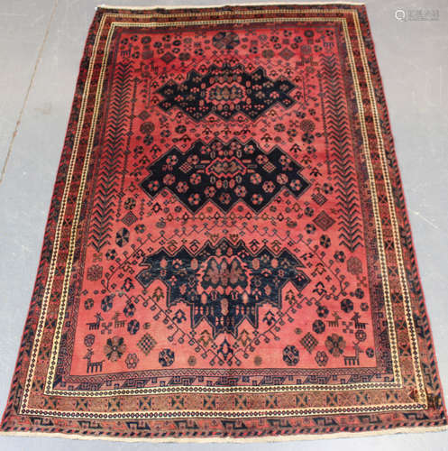 A Kurdish carpet, mid/late 20th century, the shaded pink fie...