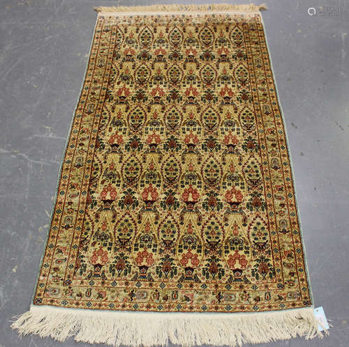 A fine Kashmir part silk rug, late 20th century, the ivory f...