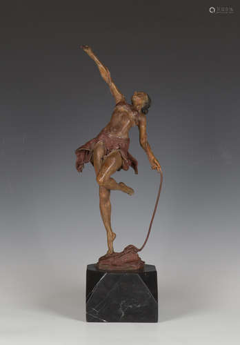 A painted cast spelter figure of an Amazonian female, holdin...