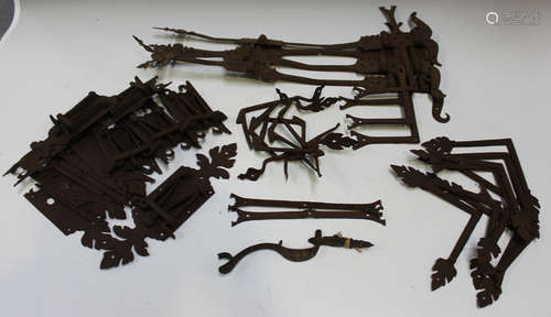 A group of ornamental wrought iron shutter mounts, probably ...