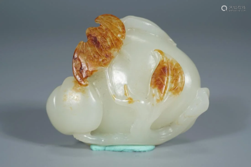 A CHINESE RUSSET JADE CARVING 'PEACH & BAT'