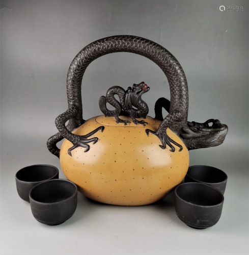 A Chinese Yixing teapot with four cups
