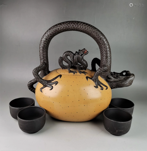 A Chinese Yixing teapot with four cups