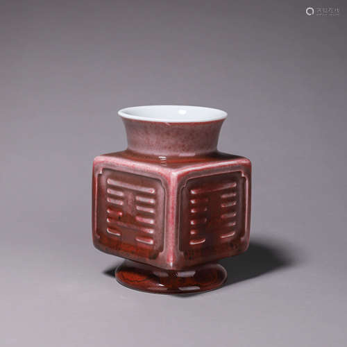 A red glazed porcelain bagua zun