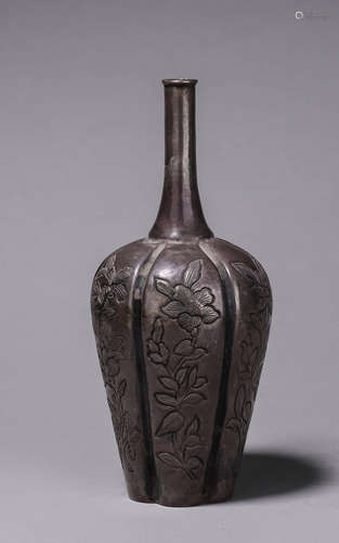 A flower patterned silver vase