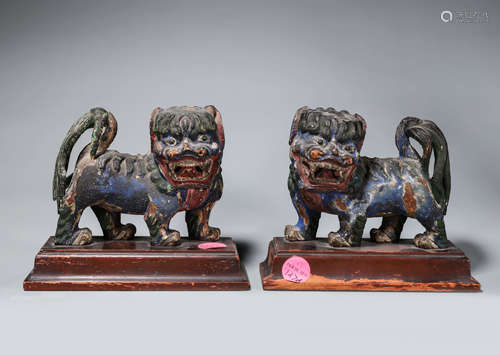 A pair of painted wood lions