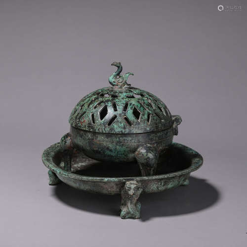 A hollowed out bronze incense burner