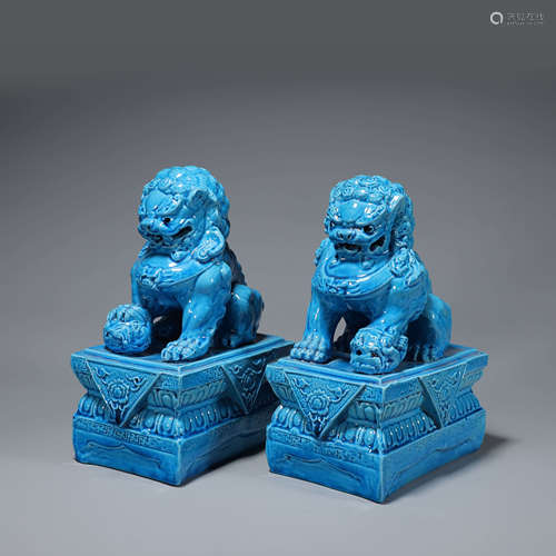 A pair of blue glazed porcelain lion ornaments