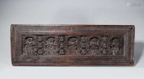 A carved wood buddhism plaque