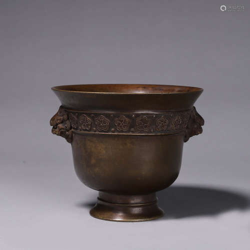 A copper censer with lion head shaped ears