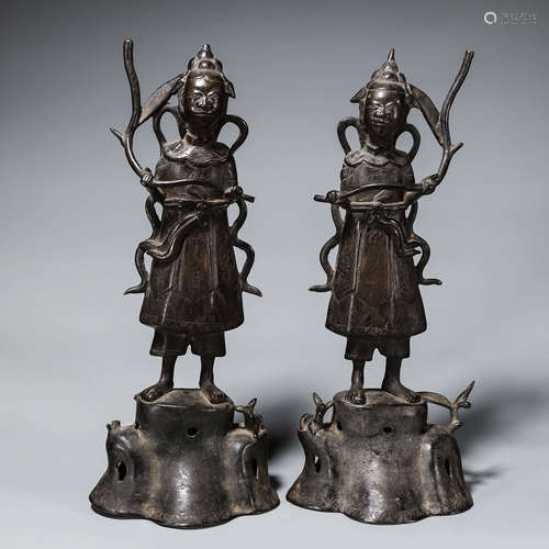 A pair of copper figure candlesticks