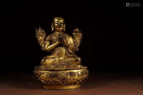 A MING DYNASTY GILDING MASTER STATUE