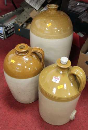 A large stoneware flagon together with two others similar