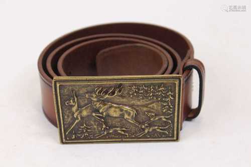 A leather belt with cast brass buckle