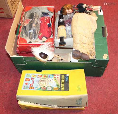 A box containing a collection of various plastic dolls and f...