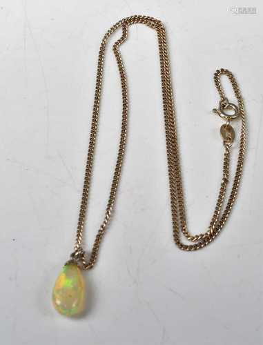 A modern polished opal pendant, weighing approx 3 carats, on...