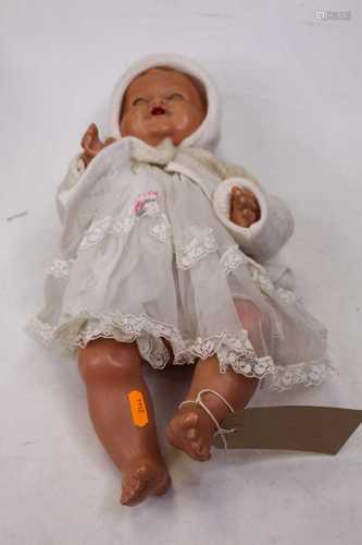 A mid-20th century composition doll, having rolling blue eye...