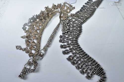 An Eastern white metal heavy necklace; together with another...