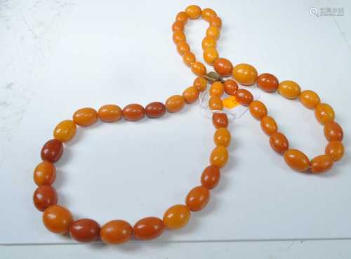 A faux butterscotch amber double-string necklace, arranged a...