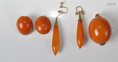 A faux butterscotch amber pendant; together with a pair of e...