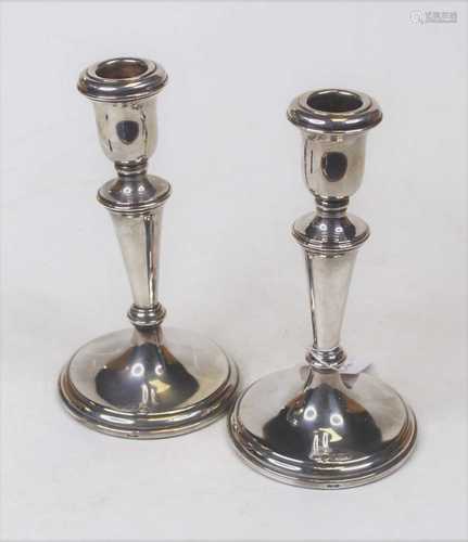 A pair of modern silver table candlesticks, each having a be...