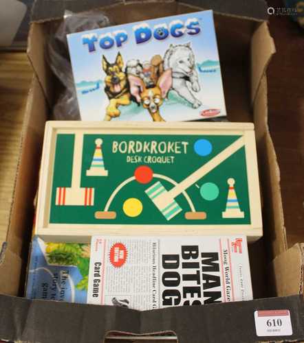 A box of various games to include desk croquet, desk top bow...