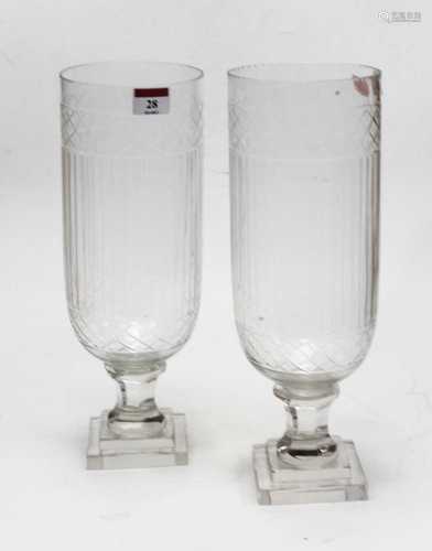 A pair of modern cut glass storm lamps each on facet cut ste...