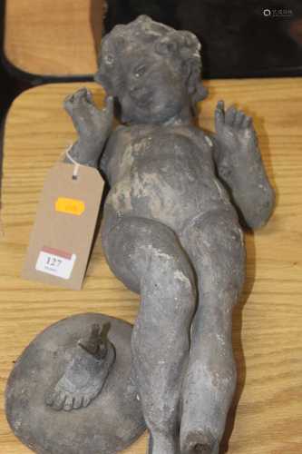 An early 20th century lead figure in the form of a cherub, i...