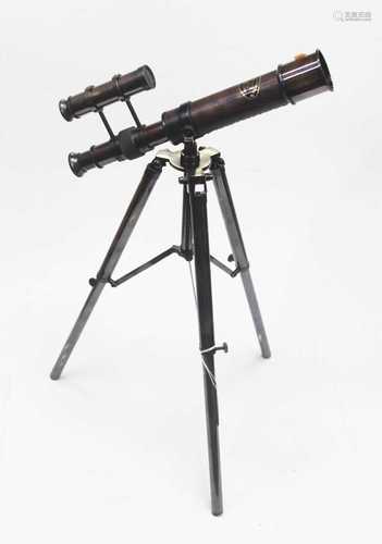 A reproduction table top telescope on folding tripod base, h...