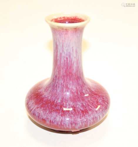 A Chinese export vase, having a flared rim to a slender neck...