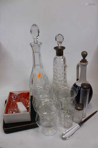 A cut glass decanter and stopper with silver collar; one oth...