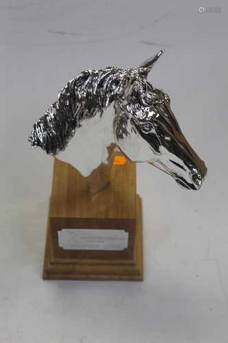 A modern horse-racing trophy, in the form of a chromed horse...