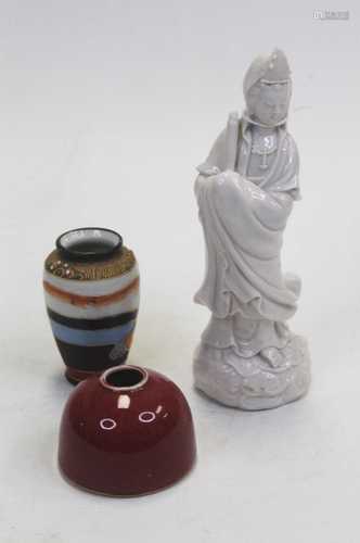 A blanc-de-china figure of Guanyin, in typical standing pose...