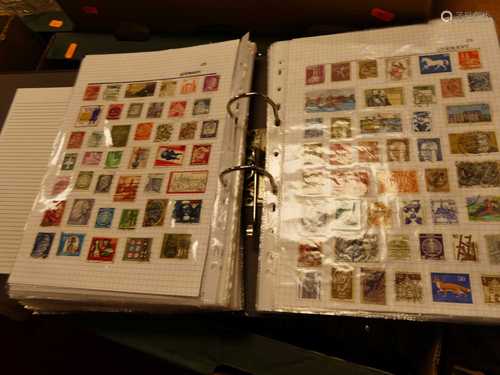 A collection of world stamps housed in four folders