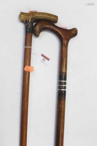 An early 20th century walking cane, having a malacca shaft w...