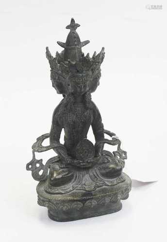 A modern bronzed figure of a deity, having four faces, in se...