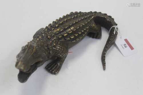 A brass alloy desk weight in the form of a crocodile, w.27cm