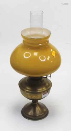 An early 20th century brass pedestal oil lamp having opalesc...